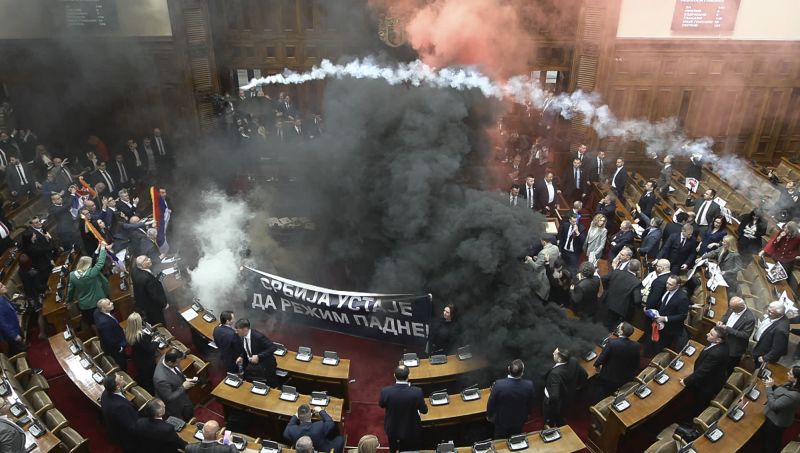 Smoke grenades tossed in Serbian parliament, lawmaker suffers stroke